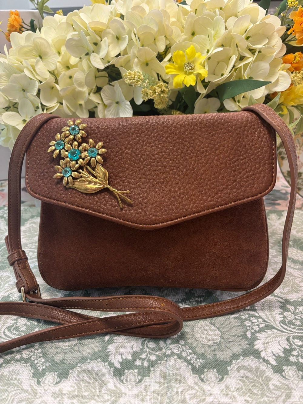 Elegant Brown Crossbody Bag with Floral Brooch